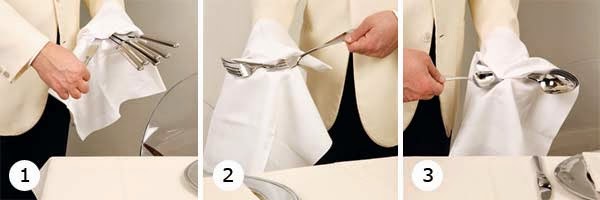 Błyszczące sztućce Przygotowanie sztućców do eleganckiego nakrycia stołu, polerowanie przed użyciem.