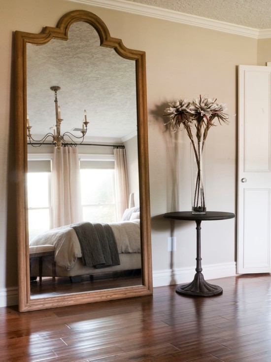 Podłogowe lustro w sypialni Duże lustro stojące na podłodze w sypialni - aranżacja małej sypialni.